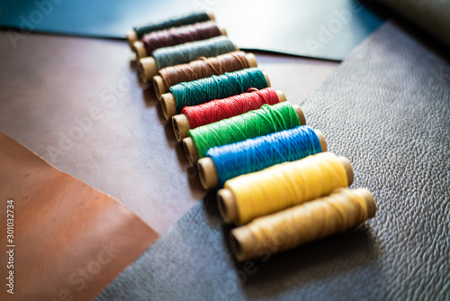 colorful linin thread on geuine leather craftmanship working photo