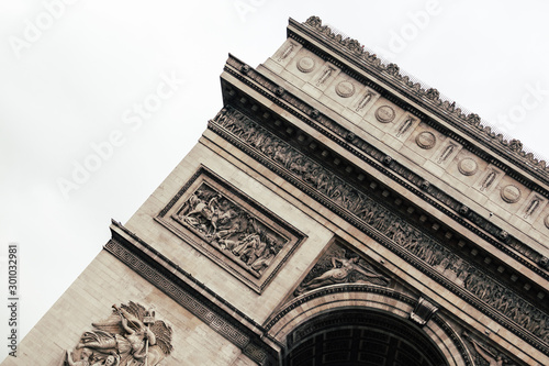 The iconic Arc the Triomphe in a blue sky day in Paris  France  Europe. Famous touristic places in Europe. European city travel concept.
