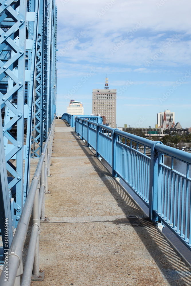 railing and sidewalk along drawbridge with blue girders in jacksonville florida