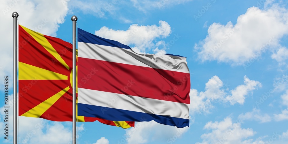 Macedonia and Costa Rica flag waving in the wind against white cloudy blue sky together. Diplomacy concept, international relations.