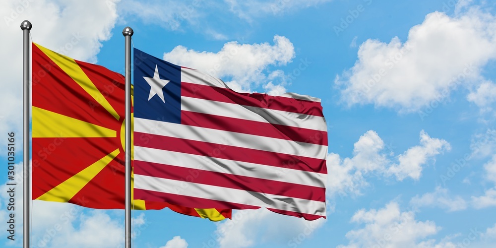 Macedonia and Liberia flag waving in the wind against white cloudy blue sky together. Diplomacy concept, international relations.