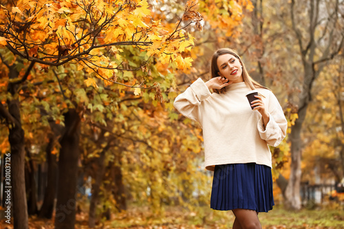 Young woman enjoying autumn...