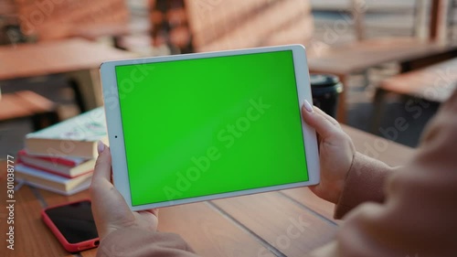 Woman hands sitting on cafe use tablet computer with horizontal green screen typing display internet touchpad connection touchscreen communication chroma finger message mobile slow motion