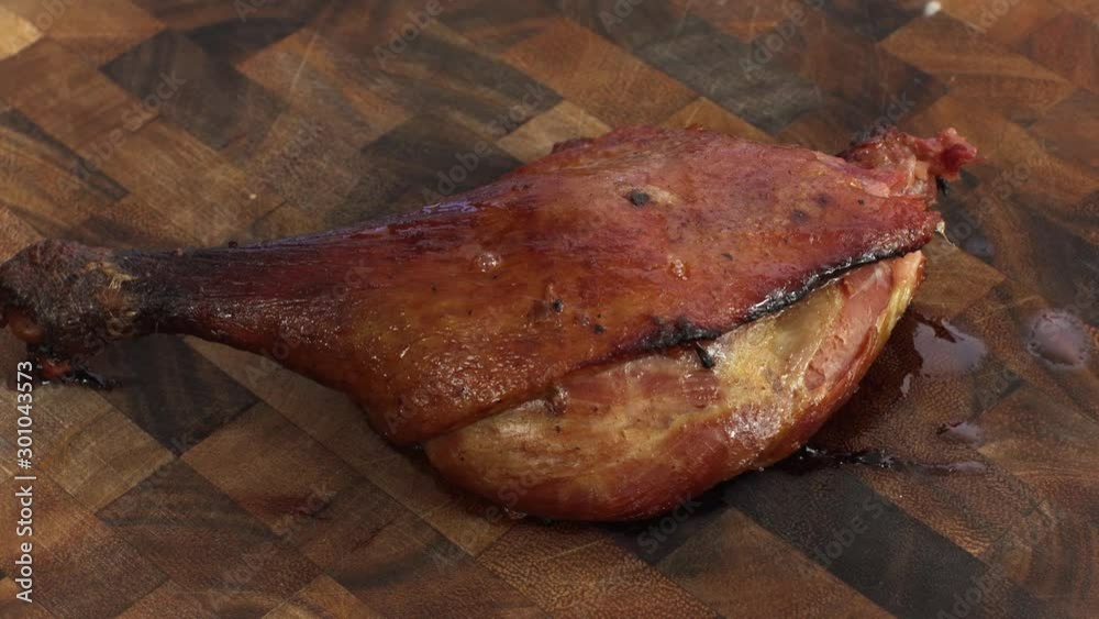 Roasted Confit Duck Leg, turning view in on wooden cutting board