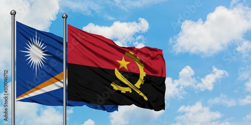 Marshall Islands and Angola flag waving in the wind against white cloudy blue sky together. Diplomacy concept, international relations.