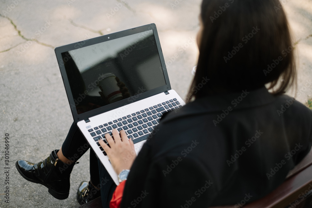 Cropped photo of woman using her laptop Cropped photo of woman using her laptop