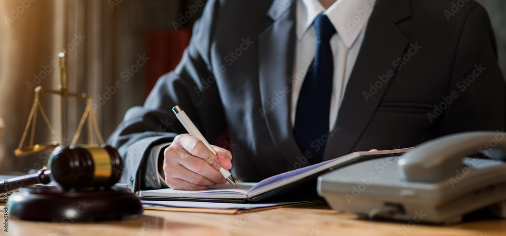 Lawyer office. gavel of Justice with scales and lawyer working on a take notes. Legal law, advice and justice concept. Lawyer office. gavel of Justice with scales and lawyer working on a take notes. Legal law, advice and justice concept.