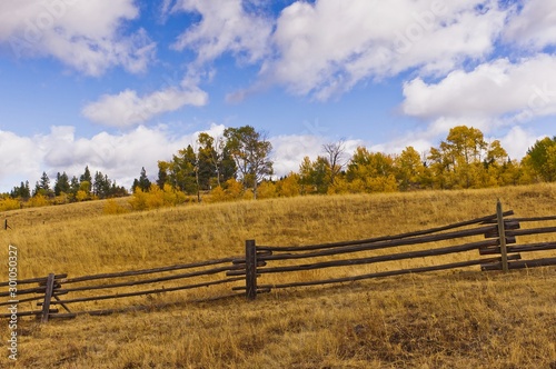 Dry golden rangeland and wood fence