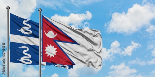 Martinique and Nepal flag waving in the wind against white cloudy blue sky together. Diplomacy concept, international relations.