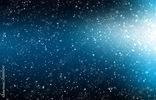 Night snowfall. Abstract texture. Bright light and dark blue shade background.