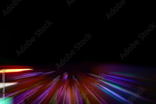 Motion blur car light trails on highway against black background