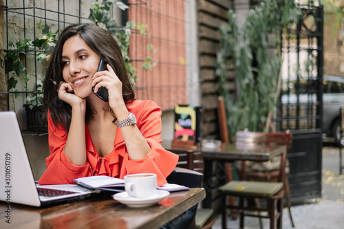 Female call operator working at street cafe