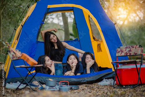 The concept of hiking, camping, hiking and living in the forest. A group of friends wake up in the morning. © Pop Sujinun