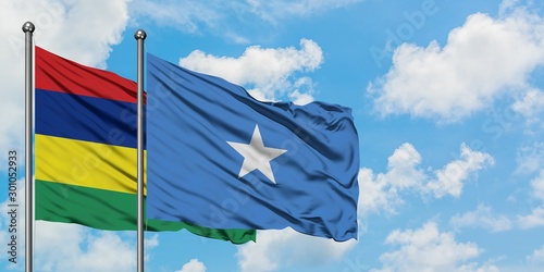 Mauritius and Somalia flag waving in the wind against white cloudy blue sky together. Diplomacy concept, international relations.
