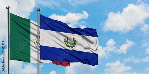 Mexico and El Salvador flag waving in the wind against white cloudy blue sky together. Diplomacy concept, international relations.