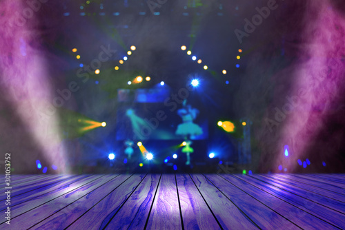 blurred concert lighting and bokeh on stage with wooden floor