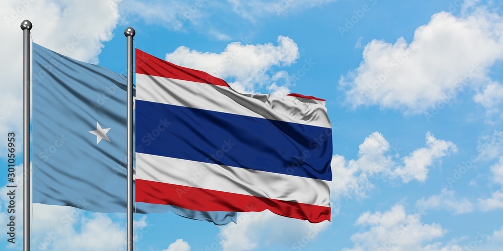 Micronesia and Thailand flag waving in the wind against white cloudy blue sky together. Diplomacy concept, international relations.