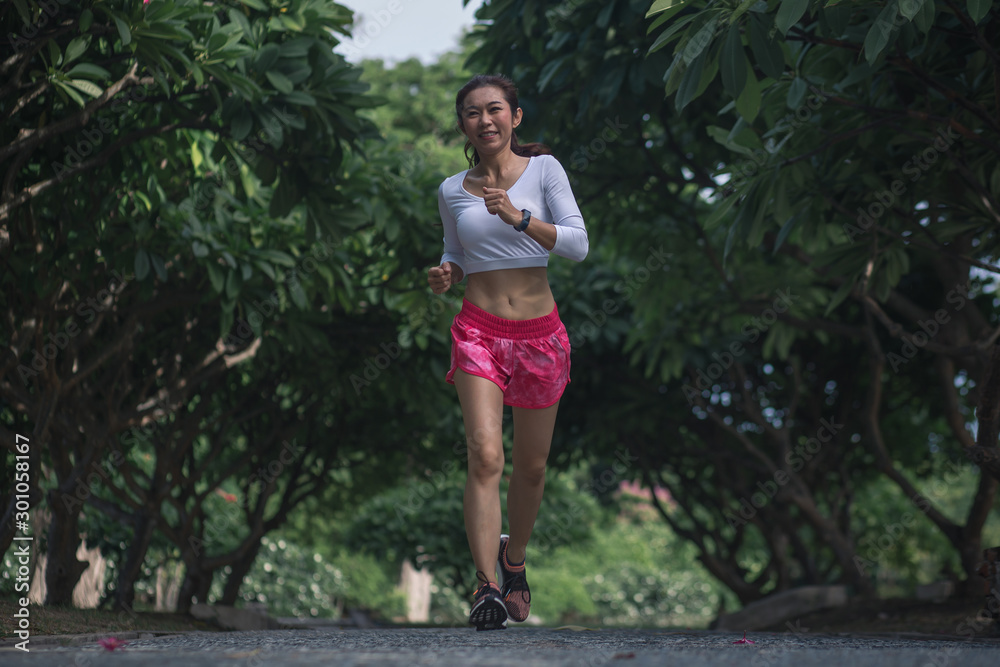 Active healthy runner jogging outdoor. Woman jogging at park