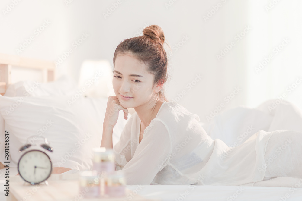 Spa, beauty products, skin care, smile, happiness Beautifully attractive mixed match Lie down on a white mattress During skin care separate on a white background Spa, beauty products, skin care, smile, happiness Beautifully attractive mixed match Lie down on a white mattress During skin care separate on a white background