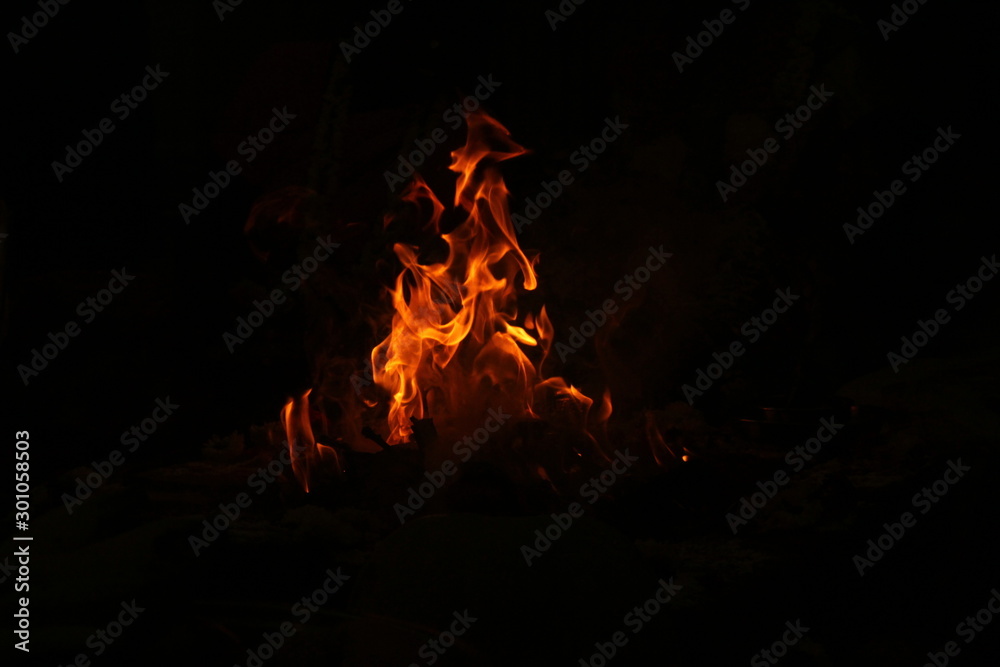 uncontrollable Fire and oil lamp fire flames on one single picture with orange / red / black and white color fire flame with black background. uncontrollable Fire and oil lamp fire flames on one single picture with orange / red / black and white color fire flame with black background.