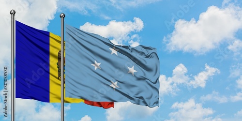Moldova and Micronesia flag waving in the wind against white cloudy blue sky together. Diplomacy concept, international relations.