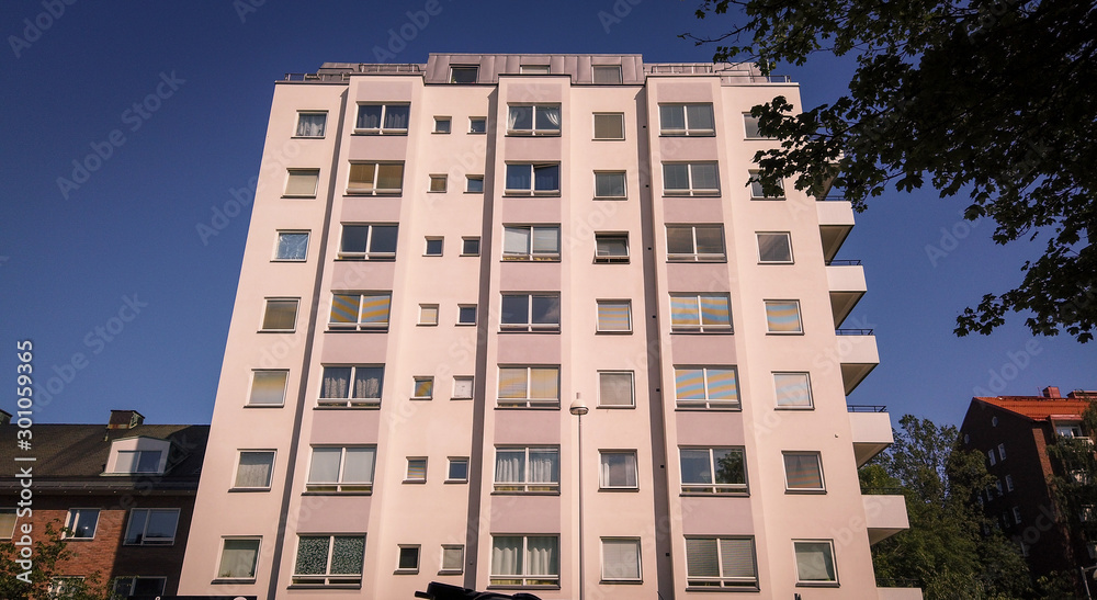 Fototapeta premium White multofloor building with blue clear sky in the background.