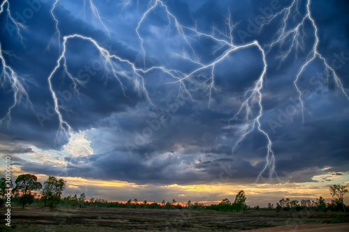 The sky is raging with rain and lightning.The sky is during the monsoon season and it is raining.