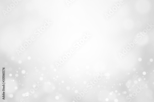 Bokeh abstract blurred silver and white beautiful background. Soft color light glitter sparkles. element for backdrop or design cosmetic ads, winter, christmas, luxury, beauty, baby