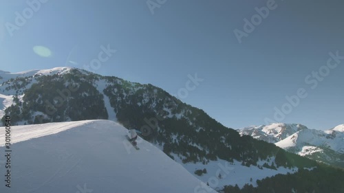 Snowboarder in Snowpark with Moving Chair Lift on Sunny Weather Day 1