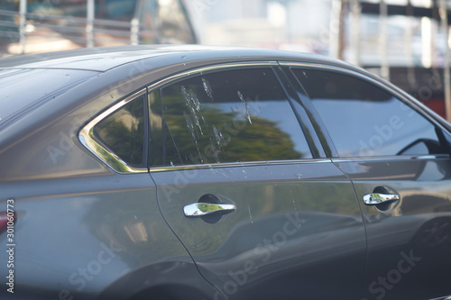 Bird poop splash on car win shield on street view