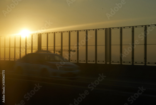 Blur photo of Car and sky road with sun rise background
