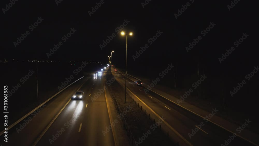 Vehicles at highway filmed from a bridge by night Vehicles at highway filmed from a bridge by night