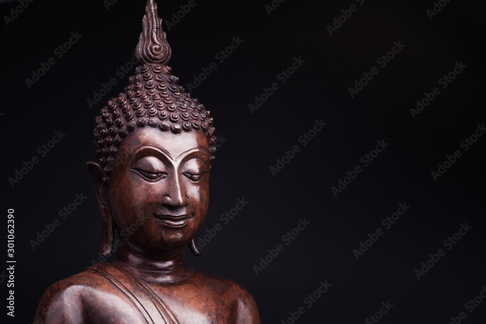 Statue of Buddha in lankian style made of wood, on black background. Statue of Buddha in lankian style made of wood, on black background.