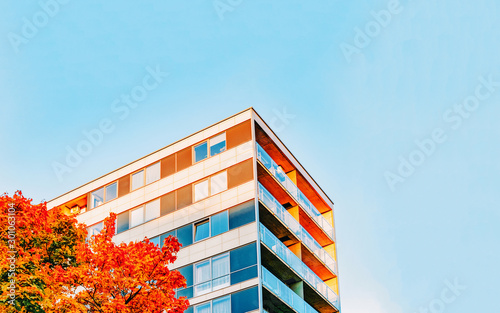 Part in Modern residential apartment with flat building exterior. Detail of New luxury house and home complex. Fragment of City Real estate property and condo architecture. Copy space. Blue sky © Roman Babakin