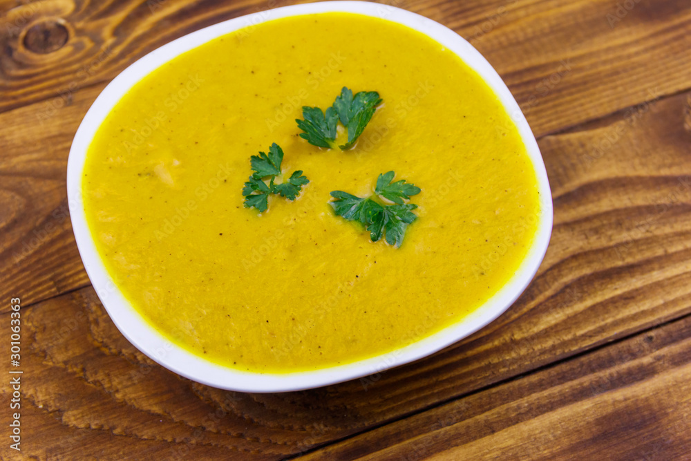 Pumpkin soup on a wooden table Pumpkin soup on a wooden table