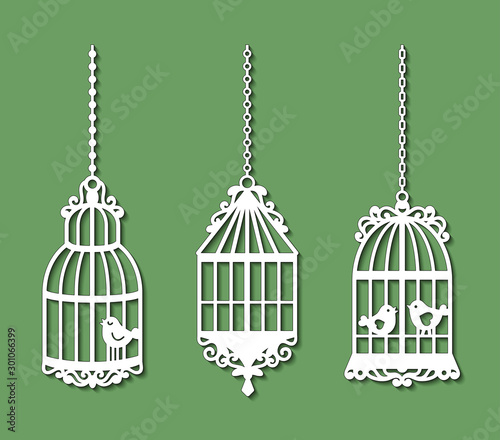 Set of laser cut template of birdcages. Openwork silhouette of cages for birds with lace ornament. Decoration for paper cutout. Design for laser or die cutting. Vector illustration on green background