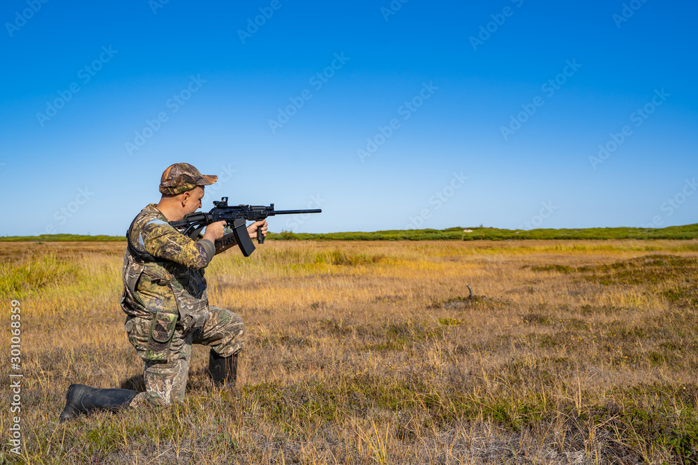 man with a gun standing in the field man with a gun standing in the field