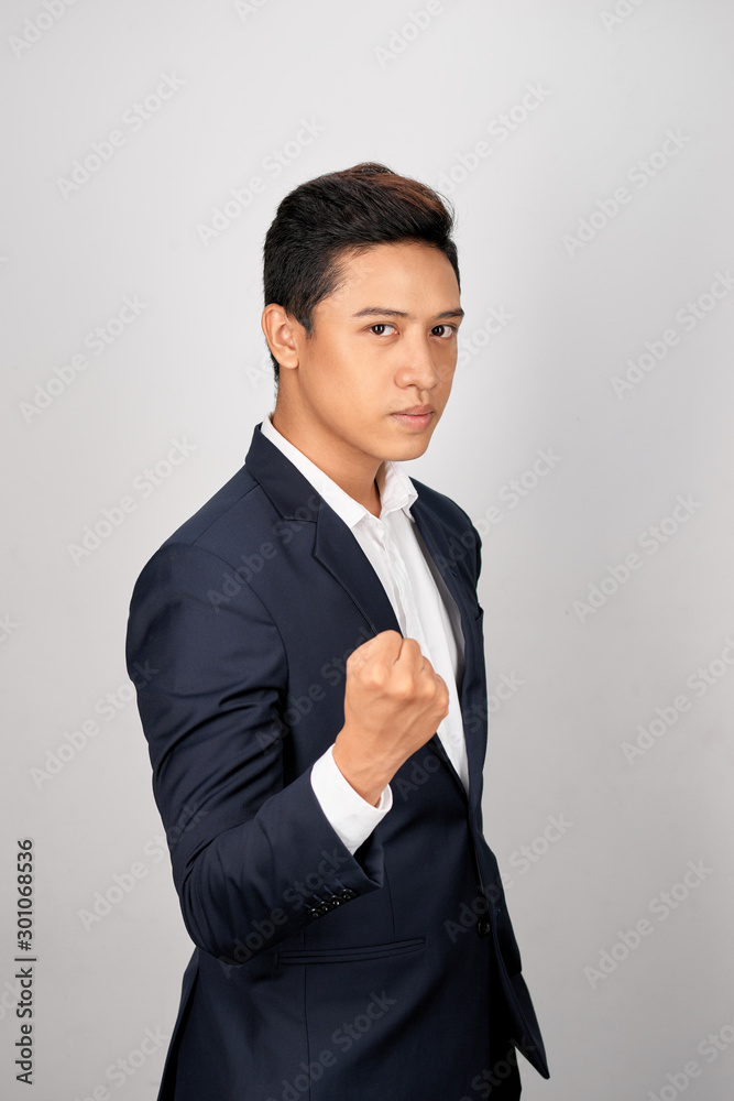 Young businessman showing a fist bump over white background Young businessman showing a fist bump over white background