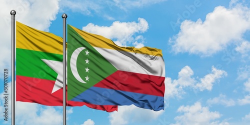 Myanmar and Comoros flag waving in the wind against white cloudy blue sky together. Diplomacy concept, international relations.