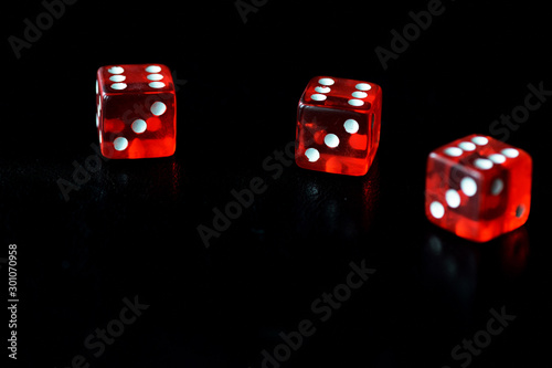 Red dice on a black background close-up. Gambling сoncept