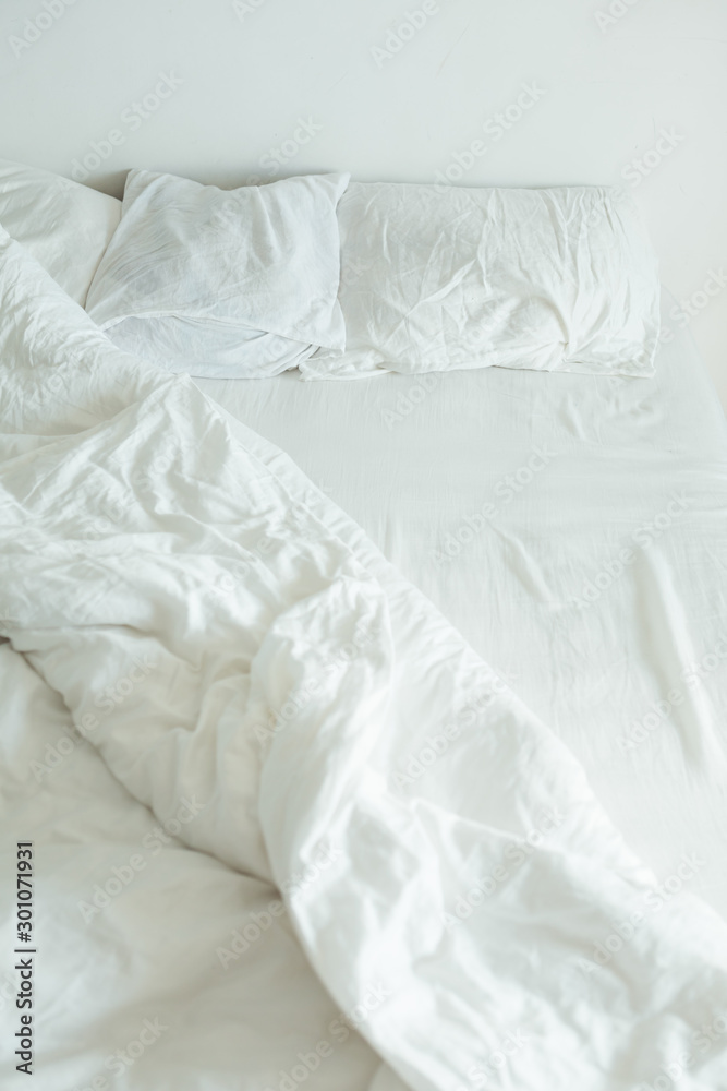 Obraz premium bed with white sheets close up bright light