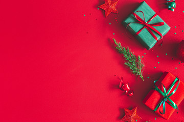 Christmas composition. Gift box, christmas decorations on red background. Flat lay, top view, copy space