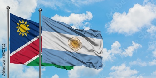 Namibia and Argentina flag waving in the wind against white cloudy blue sky together. Diplomacy concept, international relations.