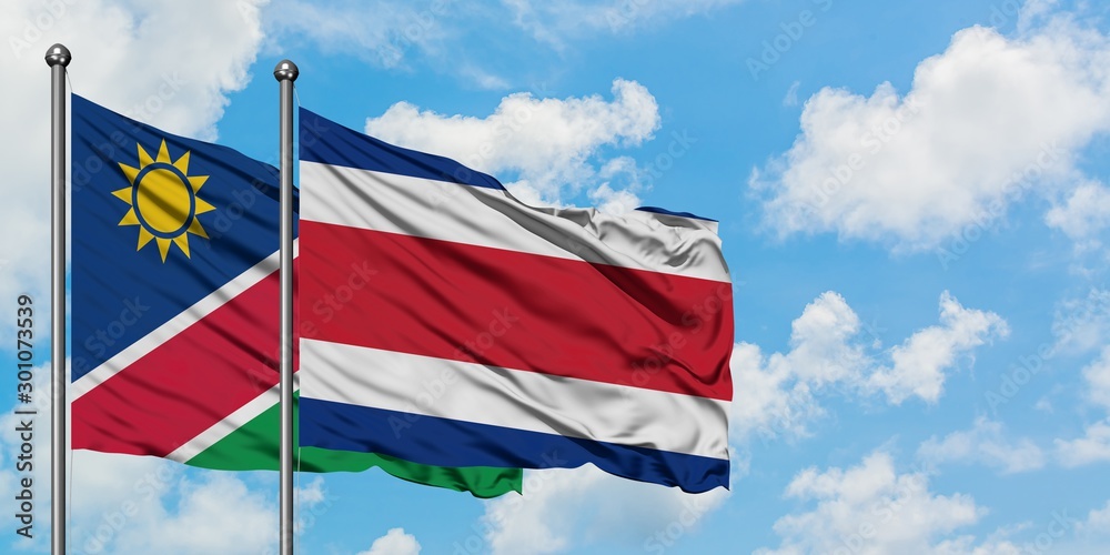 Namibia and Costa Rica flag waving in the wind against white cloudy blue sky together. Diplomacy concept, international relations.
