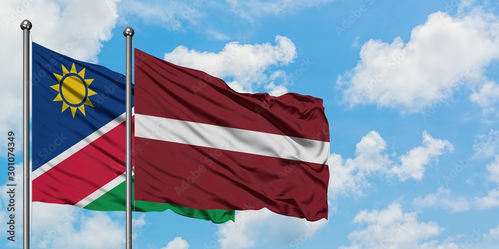 Namibia and Latvia flag waving in the wind against white cloudy blue sky together. Diplomacy concept, international relations.
