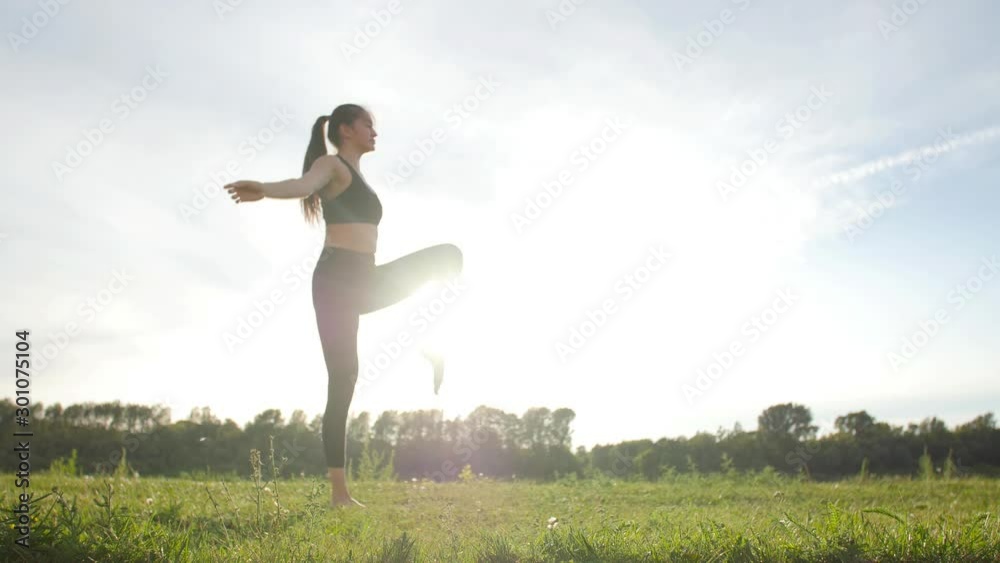 concept of health, stretching and healthy lifestyle. Young female athlete sitting on an exercising and stretching in a park at sunset. concept of health, stretching and healthy lifestyle. Young female athlete sitting on an exercising and stretching in a park at sunset.