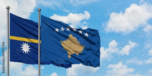 Nauru and Kosovo flag waving in the wind against white cloudy blue sky together. Diplomacy concept, international relations.