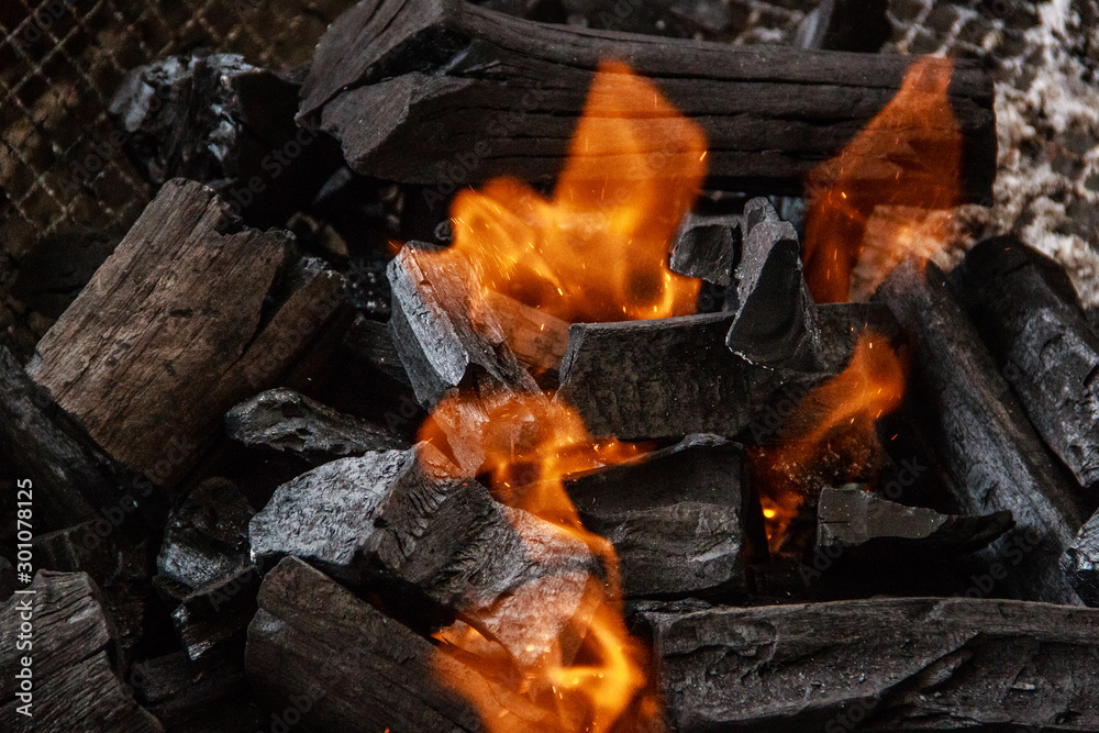 Charcoal burns in the grill