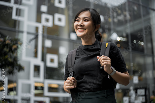 Portrait of happy asian woman in the city