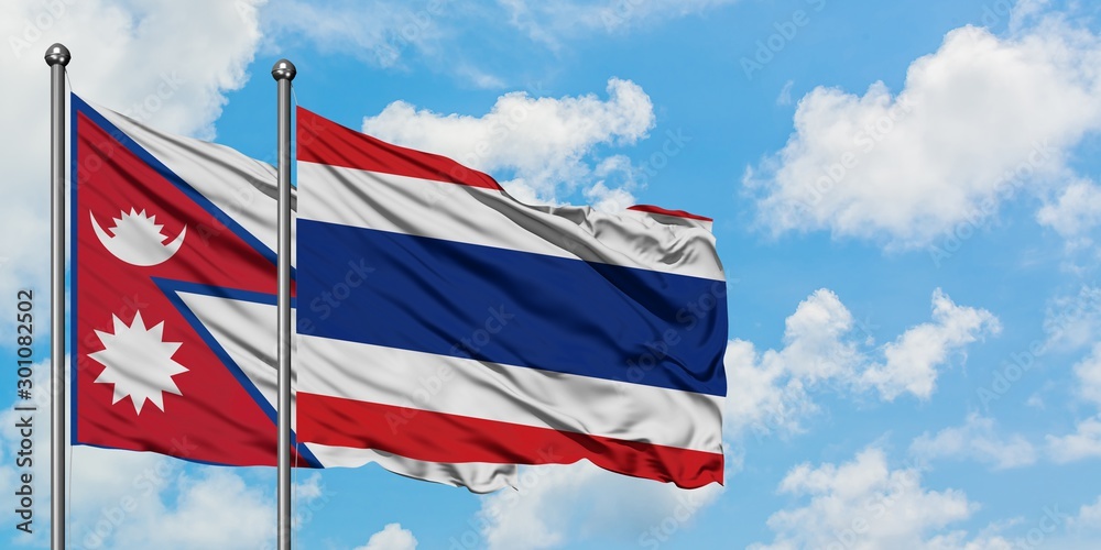 Nepal and Thailand flag waving in the wind against white cloudy blue sky together. Diplomacy concept, international relations.